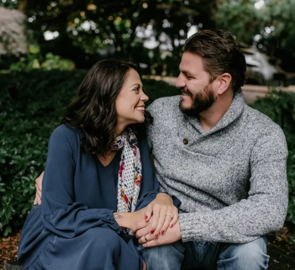 Leanna and Johnny are looking at each other while smiling.